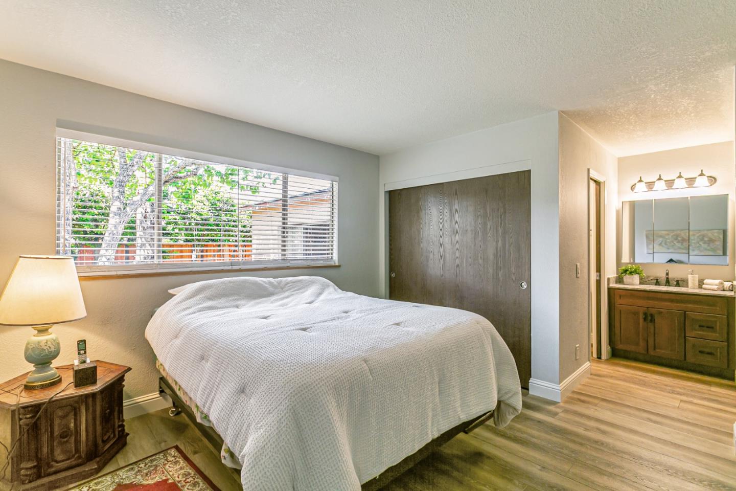 970 Ortega Circle Gilroy, CA 95020 - Photo 15 of 26 a bedroom with a bed and wooden floor