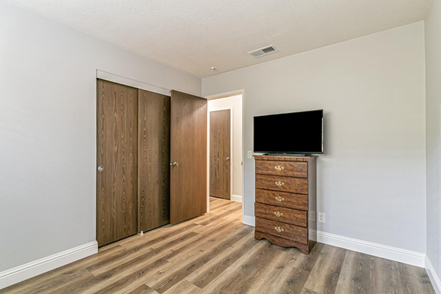 970 Ortega Circle Gilroy, CA 95020 - Photo 18 of 26 a view of room with wooden floor and flat screen tv
