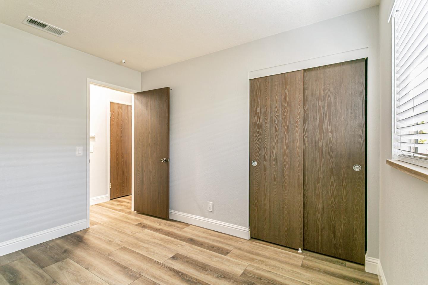 970 Ortega Circle Gilroy, CA 95020 - Photo 19 of 26 a view of wooden floor and windows in a room
