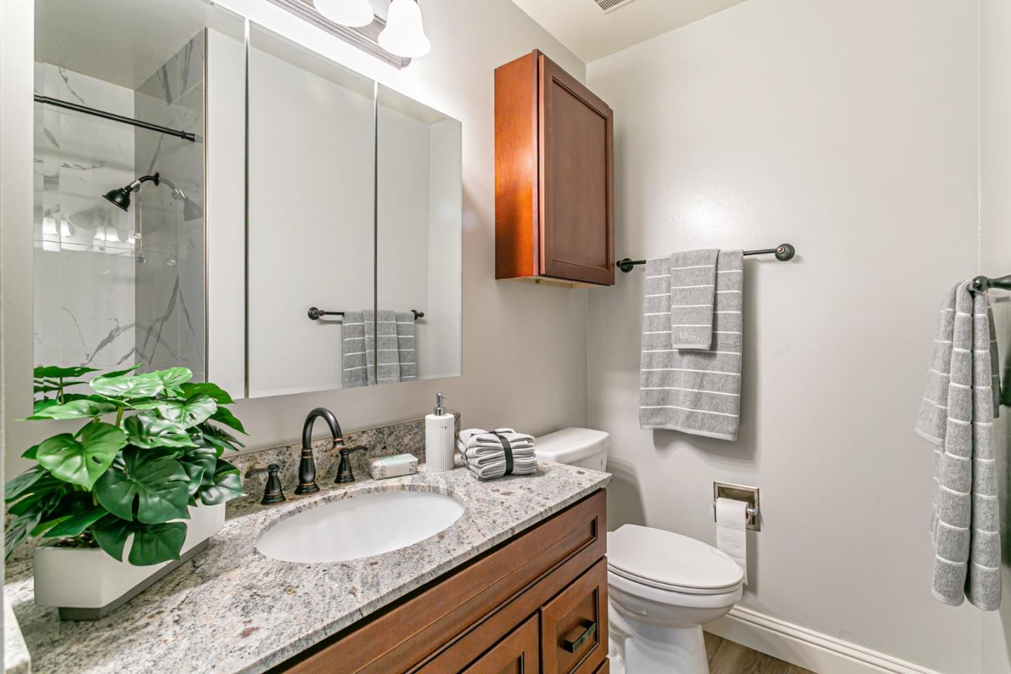 970 Ortega Circle Gilroy, CA 95020 - Photo 20 of 26 a bathroom with a granite countertop sink toilet and shower