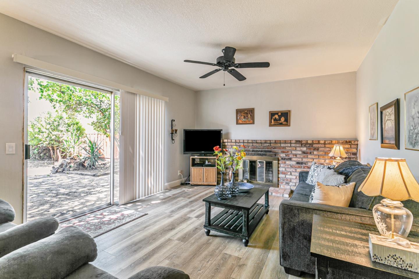 970 Ortega Circle Gilroy, CA 95020 - Photo 2 of 26 a living room with furniture a flat screen tv and a large window