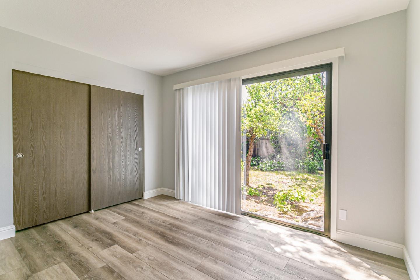 970 Ortega Circle Gilroy, CA 95020 - Photo 22 of 26 a view of an empty room with wooden floor and a window