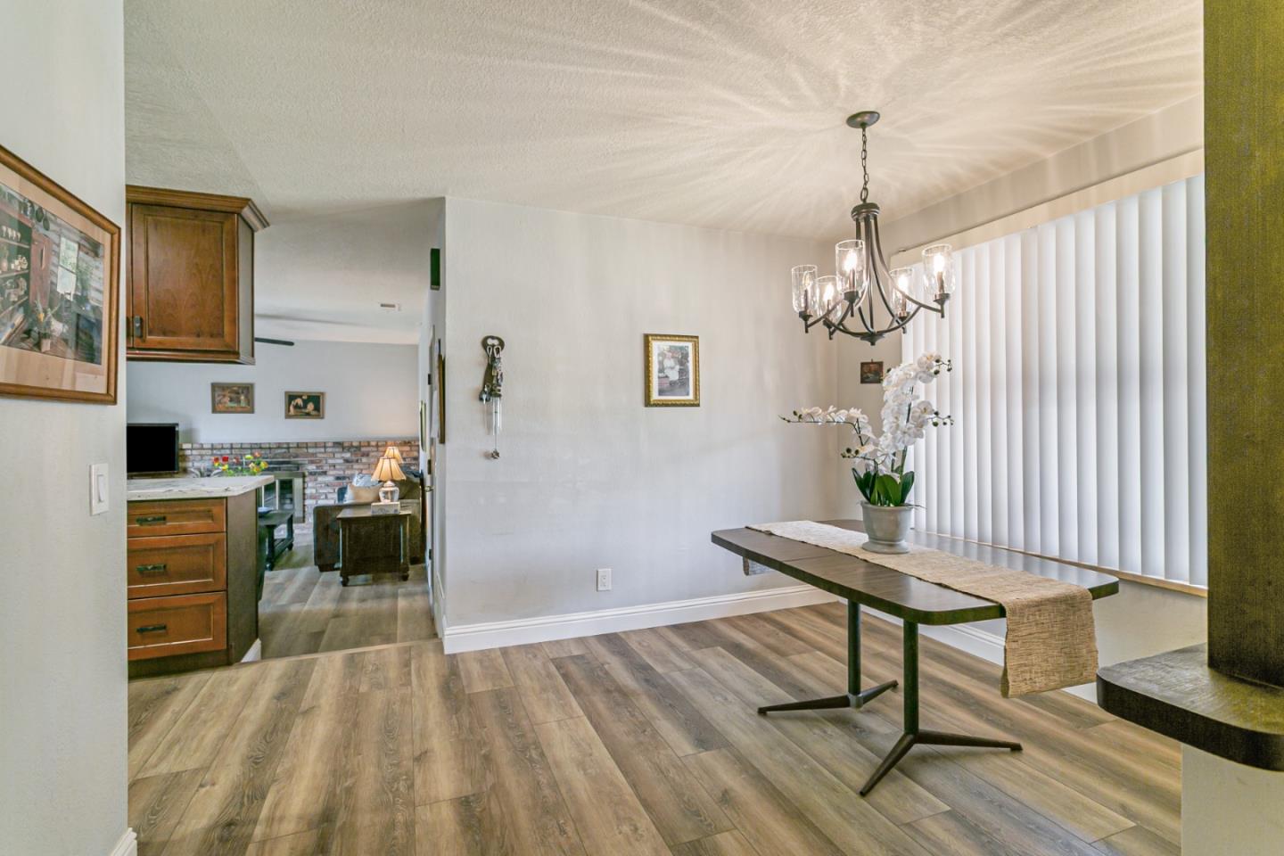 970 Ortega Circle Gilroy, CA 95020 - Photo 10 of 26 a dining room with furniture a chandelier and wooden floor
