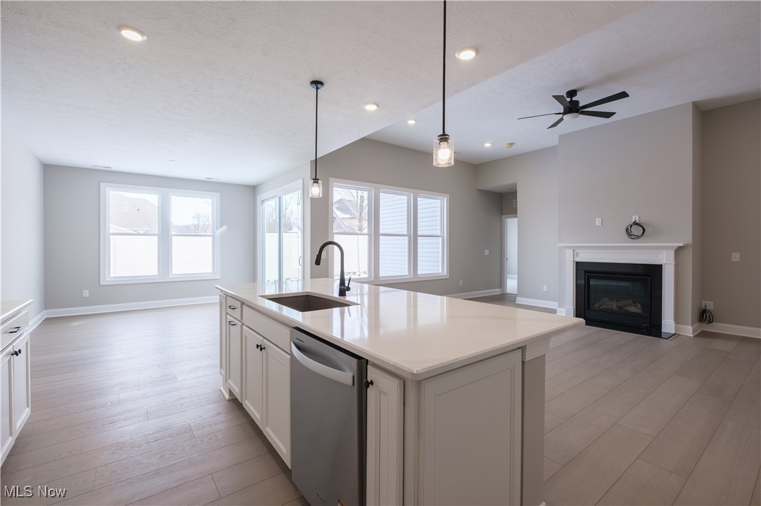 7951 Rogan Lane Painesville, OH 44077 - Photo 3 of 13 The kitchen island overlooks the gathering room and gas fireplace