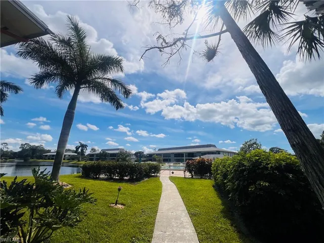 a view of a lake with a house in the background