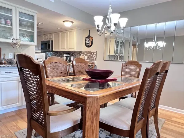 a large kitchen with stainless steel appliances granite countertop a stove top oven a refrigerator and white cabinets