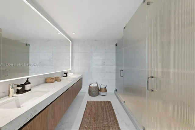 a bathroom with a double vanity sink and mirror