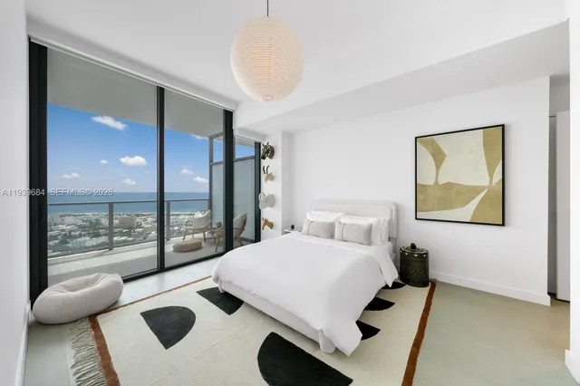 a bedroom with a bed and glass door