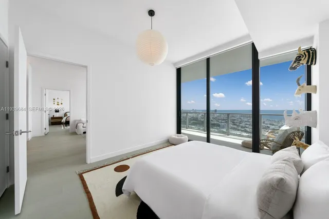 a bedroom with a bed and a large mirror