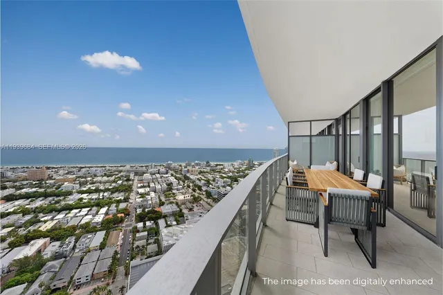 a balcony with chairs and table