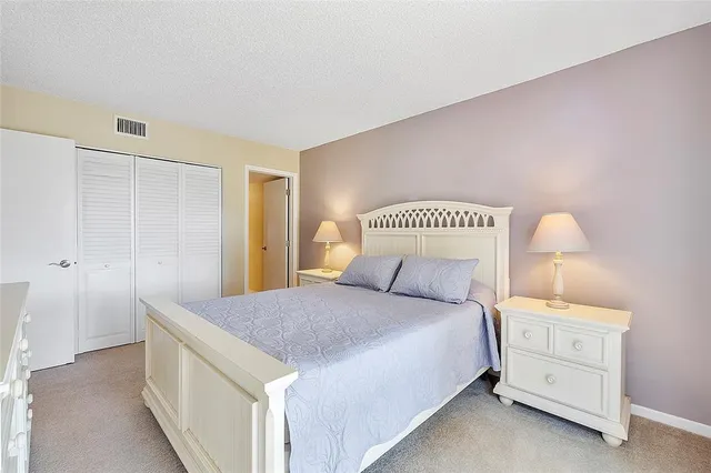 a bedroom with a bed and a night stand