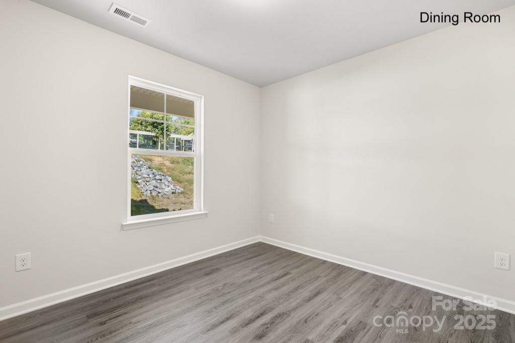 319 Connor Street Lancaster, SC 29720 - Photo 11 of 47 an empty room with wooden floor and windows