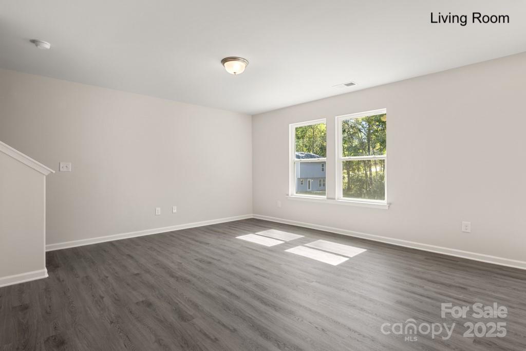 319 Connor Street Lancaster, SC 29720 - Photo 13 of 47 an empty room with wooden floor and windows