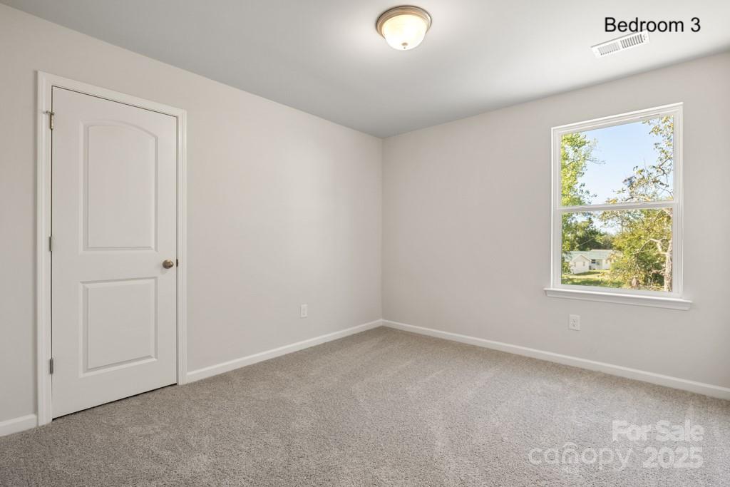 319 Connor Street Lancaster, SC 29720 - Photo 21 of 47 an empty room with windows