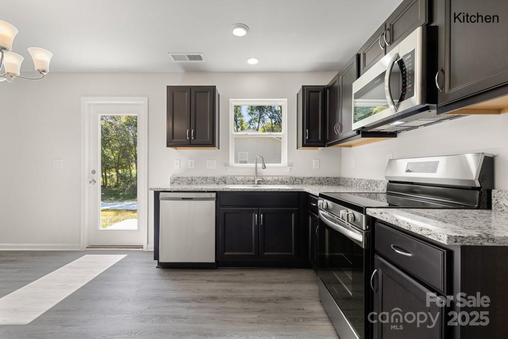 319 Connor Street Lancaster, SC 29720 - Photo 5 of 47 a kitchen with stainless steel appliances granite countertop a stove a sink and a microwave