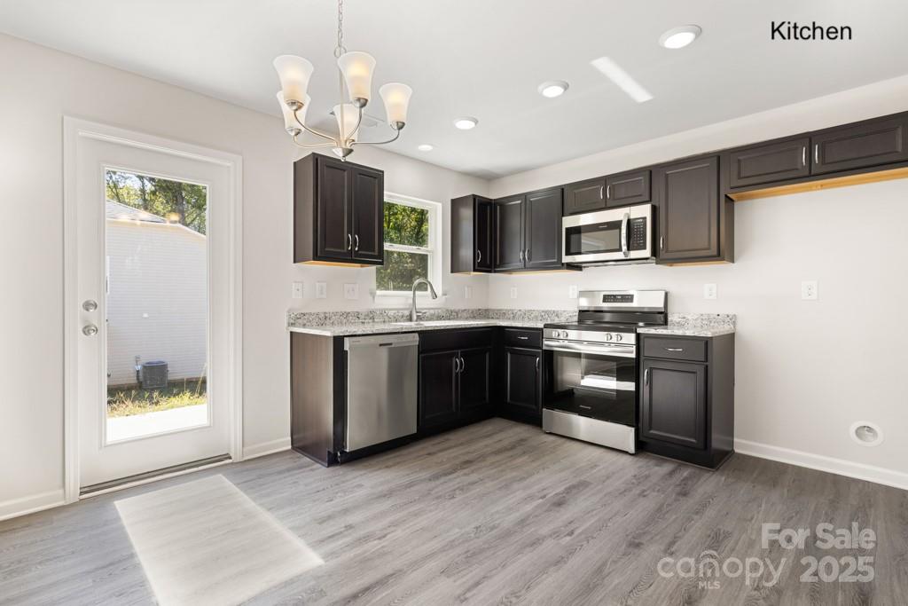 319 Connor Street Lancaster, SC 29720 - Photo 6 of 47 a kitchen with stainless steel appliances granite countertop a stove a sink and a refrigerator