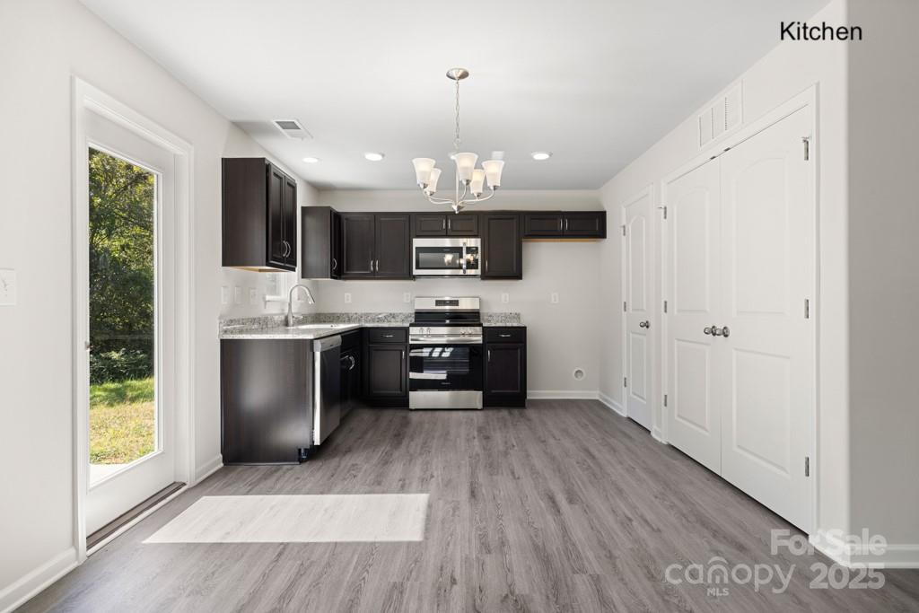 319 Connor Street Lancaster, SC 29720 - Photo 7 of 47 a kitchen with stainless steel appliances granite countertop a stove a sink and a refrigerator