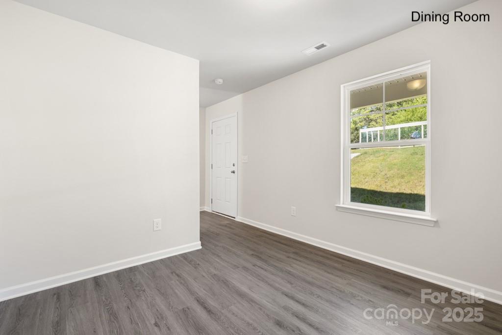 319 Connor Street Lancaster, SC 29720 - Photo 10 of 47 an empty room with wooden floor and windows