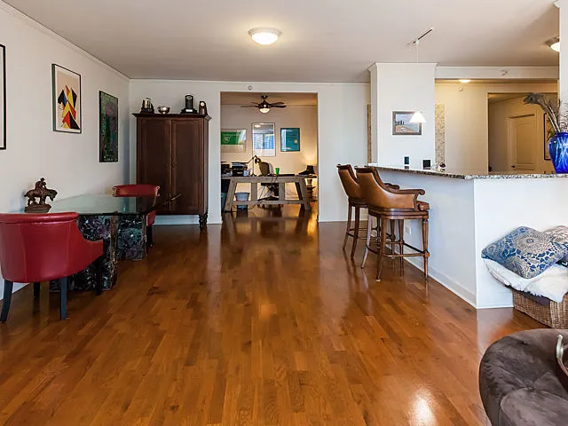 a living room with furniture and wooden floor
