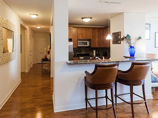 a kitchen with a table chairs and a refrigerator