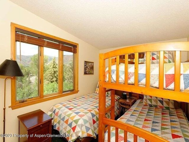 a bed sitting in a bedroom next to a window