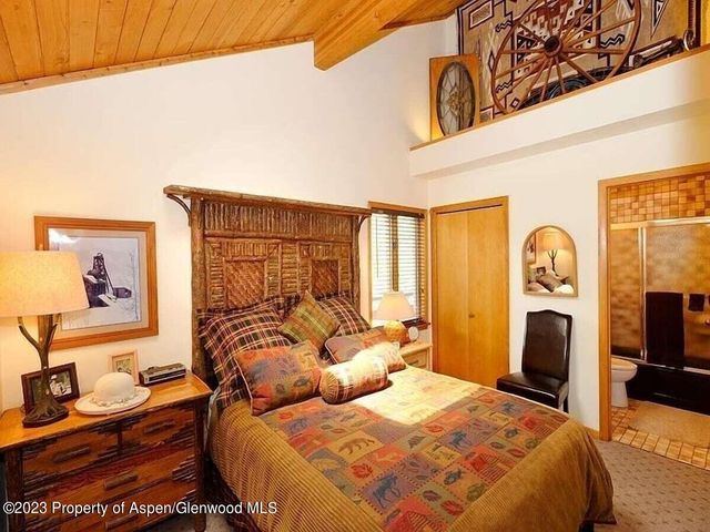 a bedroom with double bed and a window