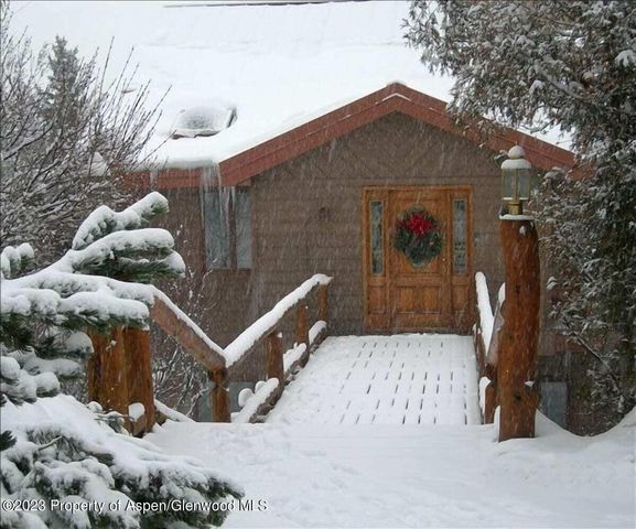 a view of a two chairs in front of house