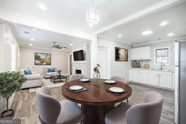 a view of a dining room with furniture and wooden floor