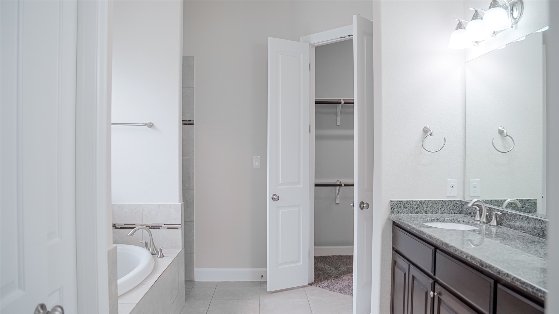 184 Fort Cobb Way Georgetown, TX 78628 - Photo 26 of 33 a bathroom with a granite countertop sink and a mirror