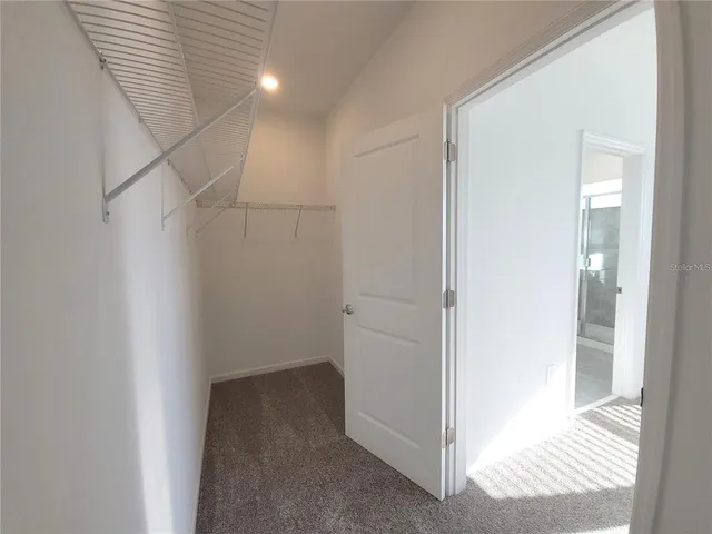 a view of an empty room with a white walls