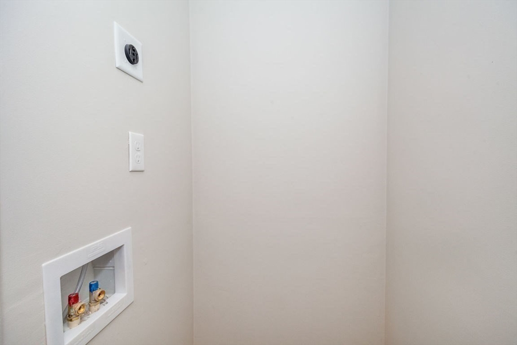 53 River Street, Unit 53 Boston, MA 02126 - Photo 12 of 25 a view of a hallway with paintings on the wall