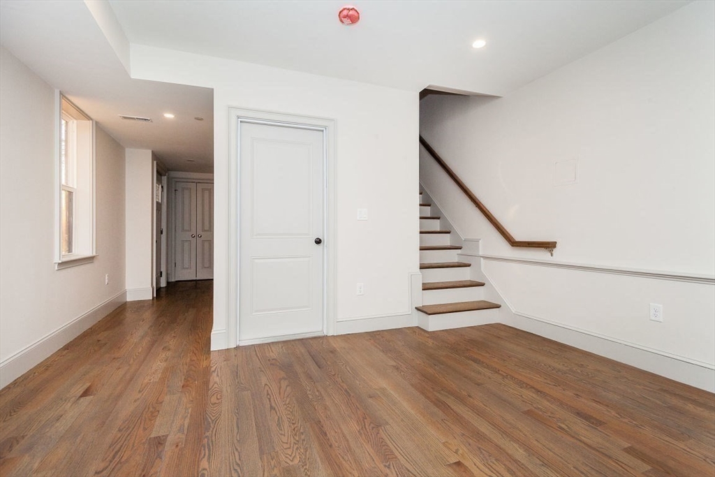 53 River Street, Unit 53 Boston, MA 02126 - Photo 15 of 25 a view of a hallway with wooden floor and staircase