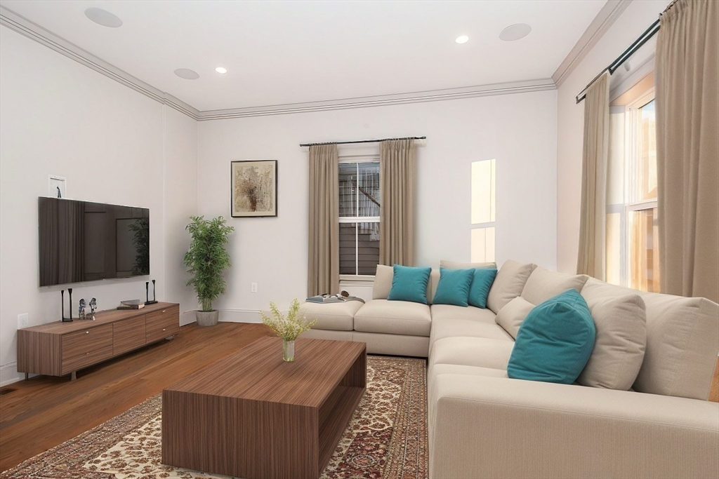 53 River Street, Unit 53 Boston, MA 02126 - Photo 4 of 25 a living room with furniture and a flat screen tv