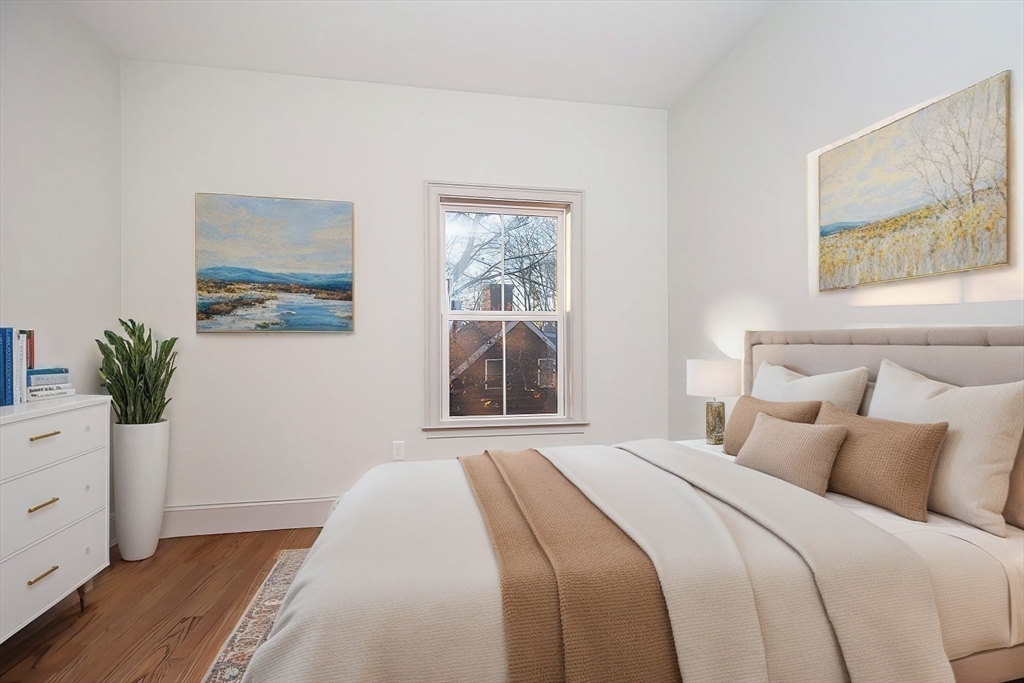 53 River Street, Unit 53 Boston, MA 02126 - Photo 5 of 25 a bedroom with a bed and a window