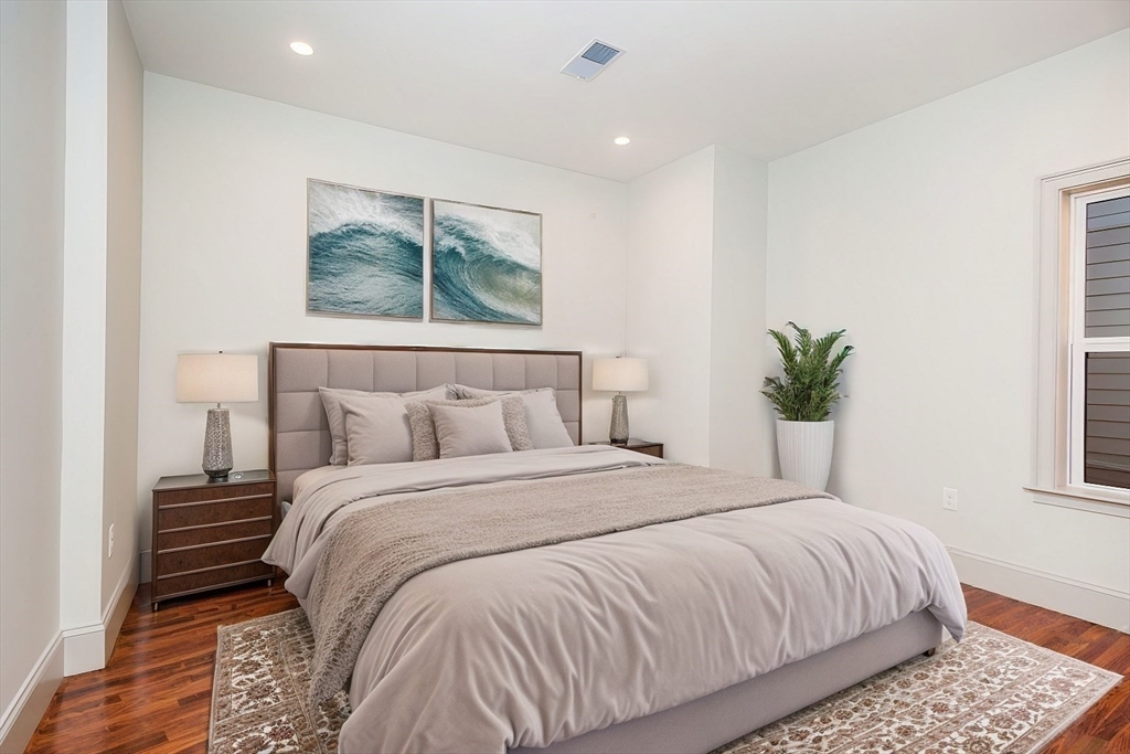 53 River Street, Unit 53 Boston, MA 02126 - Photo 6 of 25 a bedroom with a large bed and a window
