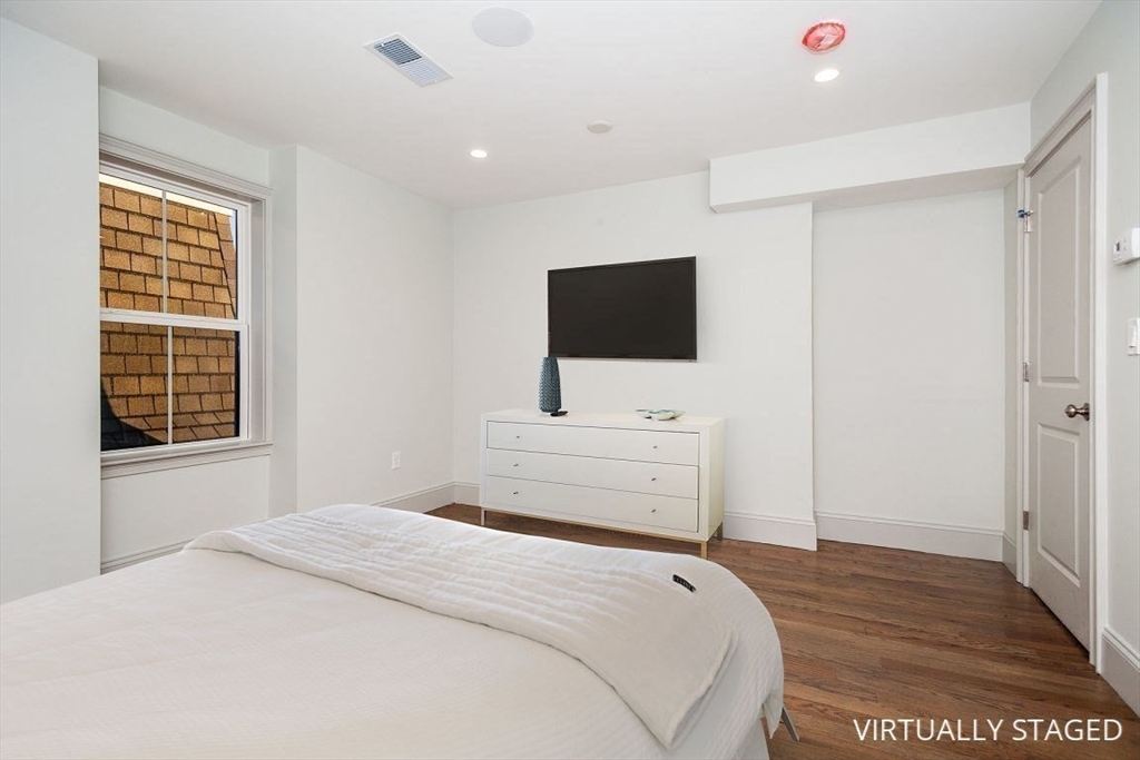 53 River Street, Unit 53 Boston, MA 02126 - Photo 9 of 25 a bedroom with a bed and a flat screen tv