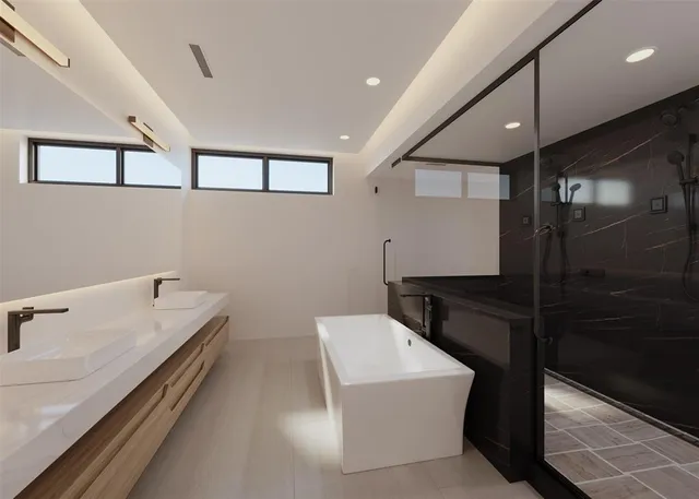 a bathroom with a double vanity sink a mirror and a bathtub
