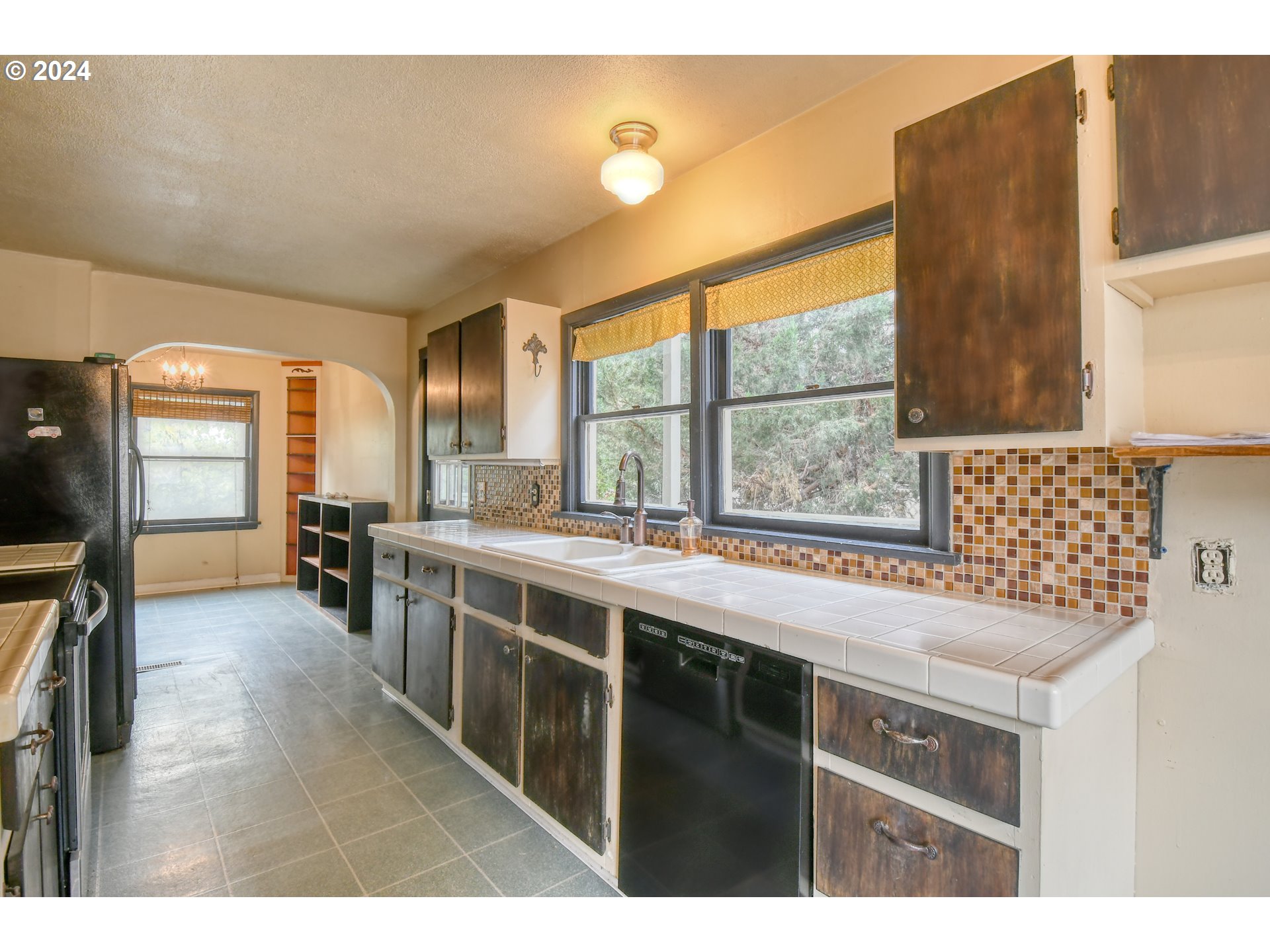 323 North Main Street Pendleton, OR 97801 - Photo 16 of 48 a open kitchen with stainless steel appliances granite countertop a sink and wooden cabinets