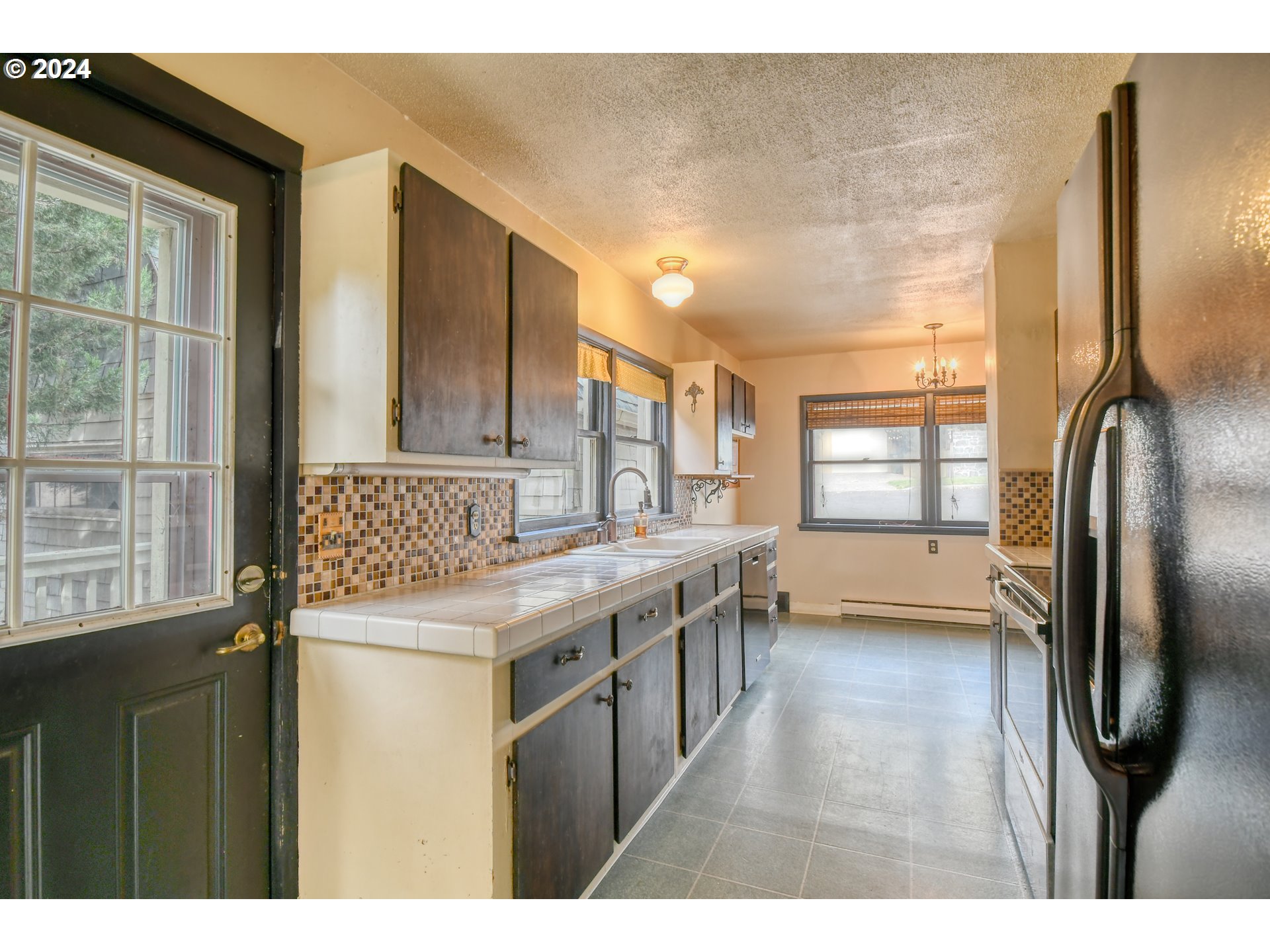 323 North Main Street Pendleton, OR 97801 - Photo 17 of 48 a kitchen with stainless steel appliances granite countertop a refrigerator a sink a stove and island