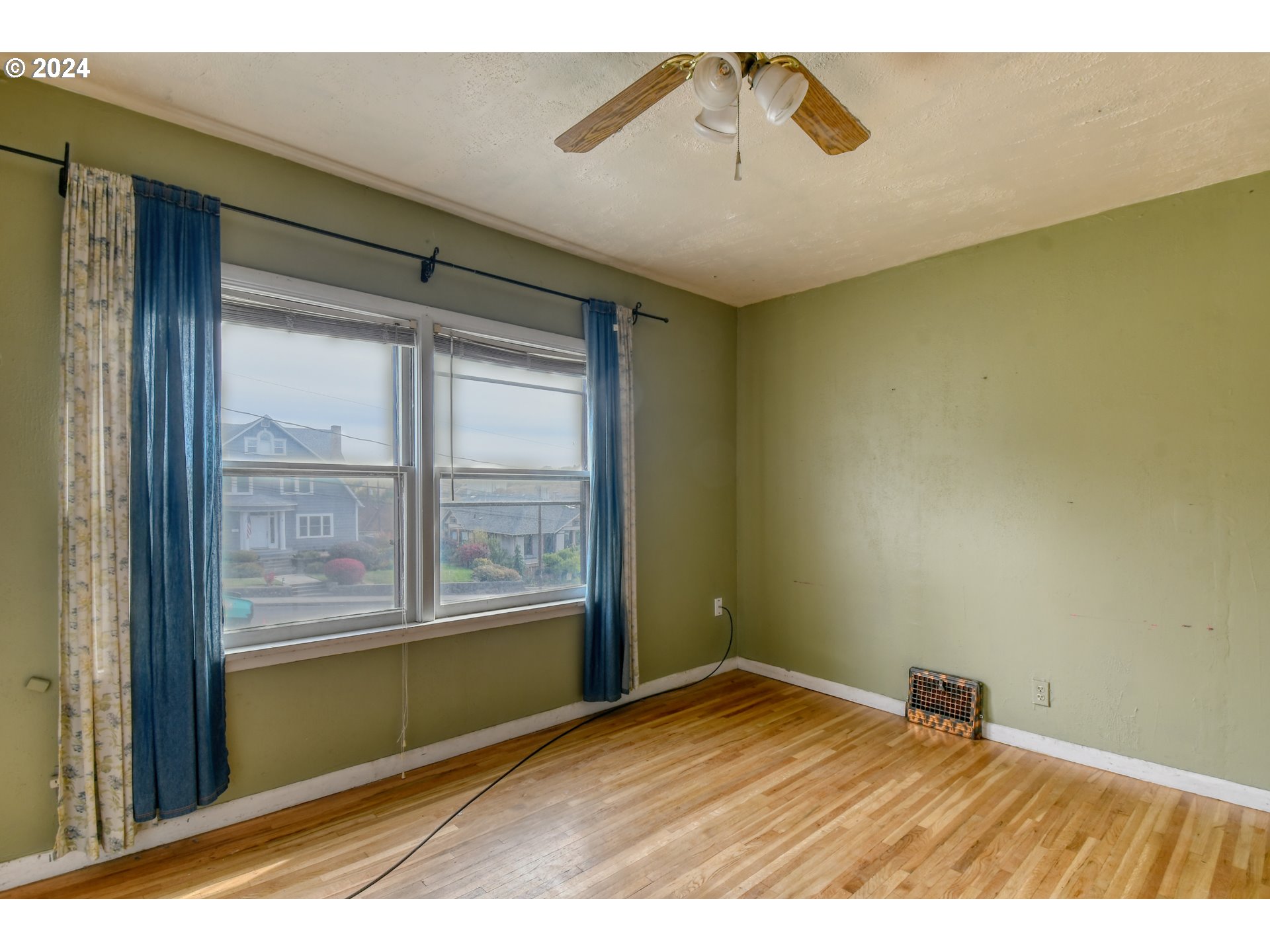 323 North Main Street Pendleton, OR 97801 - Photo 29 of 48 a view of an empty room with a window and wooden floor