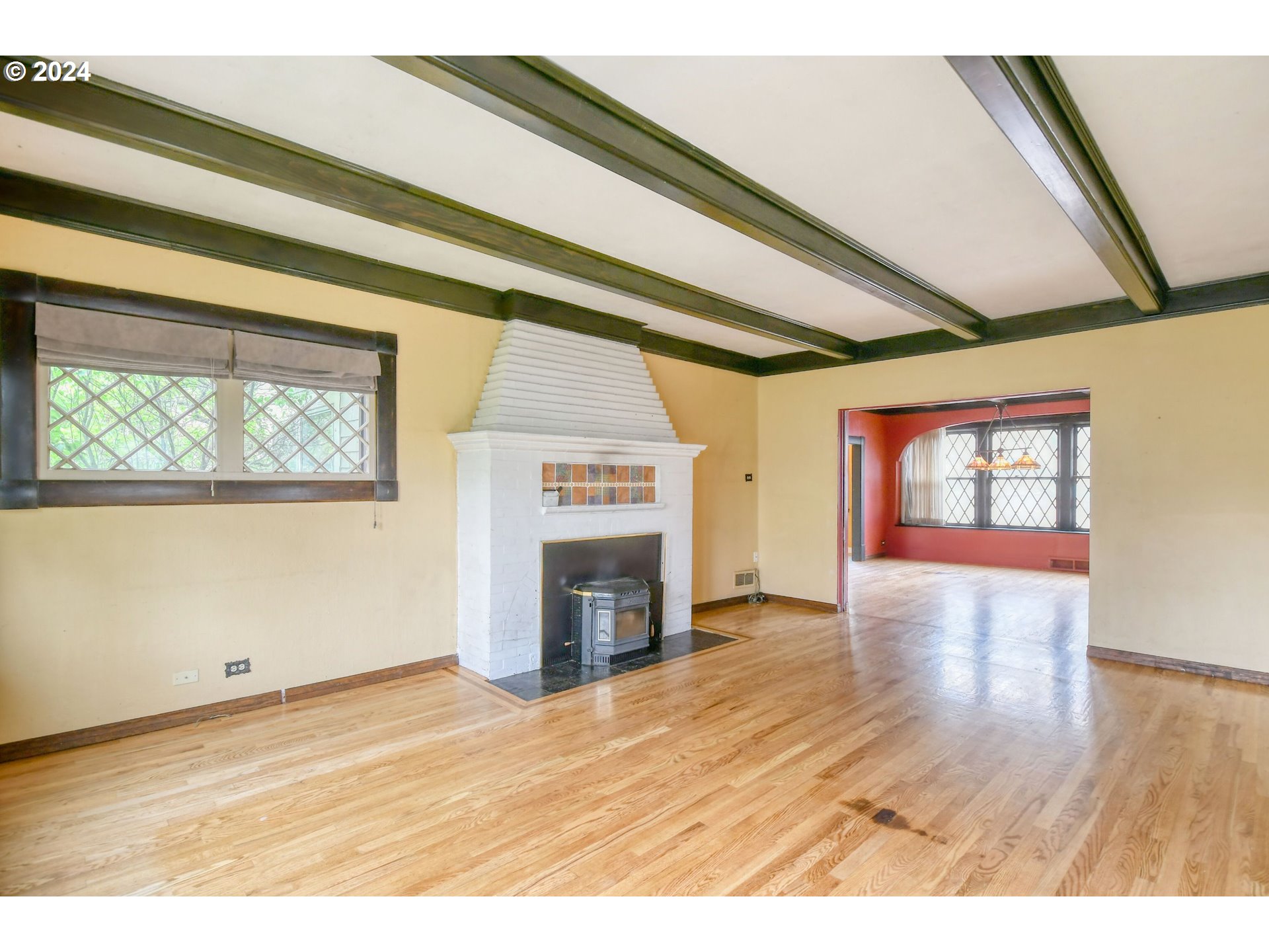 323 North Main Street Pendleton, OR 97801 - Photo 6 of 48 en empty room with wooden floor fireplace and windows