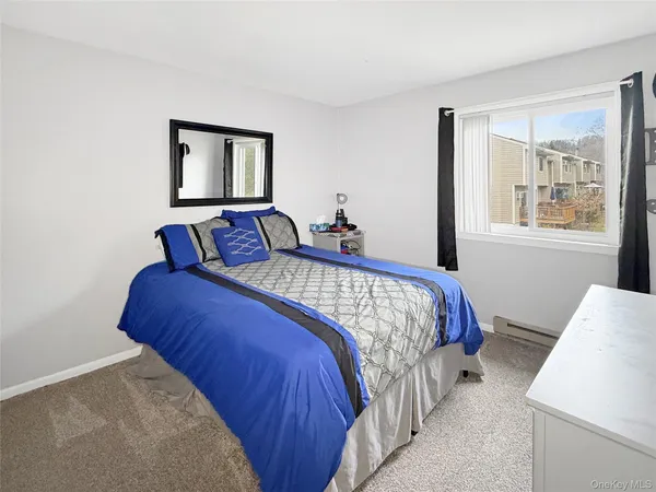 a bedroom with bed and window