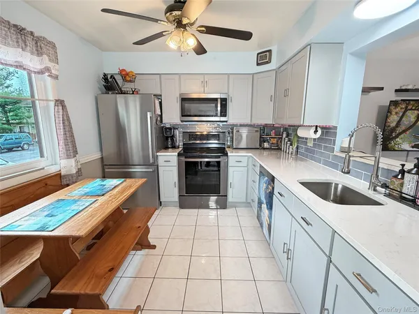 a kitchen with stainless steel appliances a sink and a refrigerator