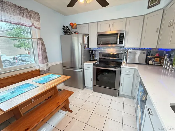 a kitchen with granite countertop a refrigerator and a stove