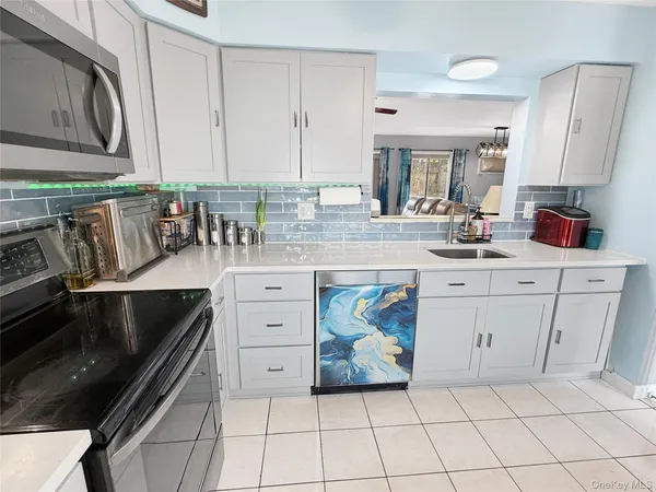 a kitchen with stainless steel appliances a sink stove and cabinets
