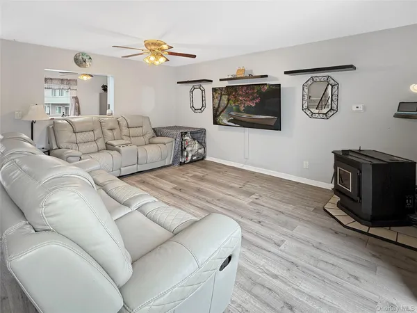 a living room with furniture flat screen tv and a couch