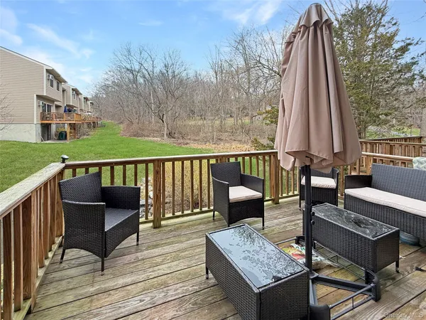 a view of a deck with couches and wooden floor