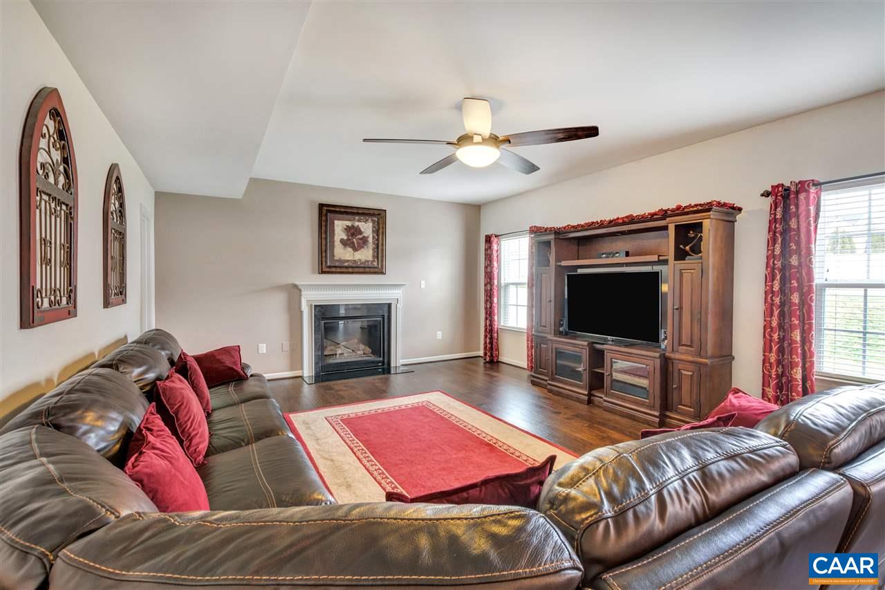 365 Ridgemont Road Ruckersville, VA 22968 - Photo 16 of 50 a living room with furniture a flat screen tv and a fireplace