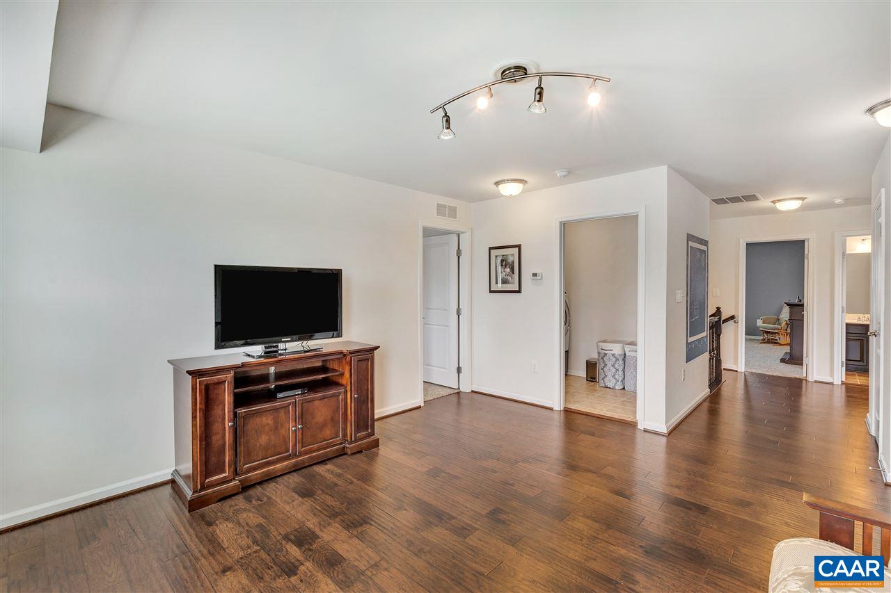 365 Ridgemont Road Ruckersville, VA 22968 - Photo 21 of 50 a view of a livingroom with a flat screen tv wooden floor and a ceiling fan