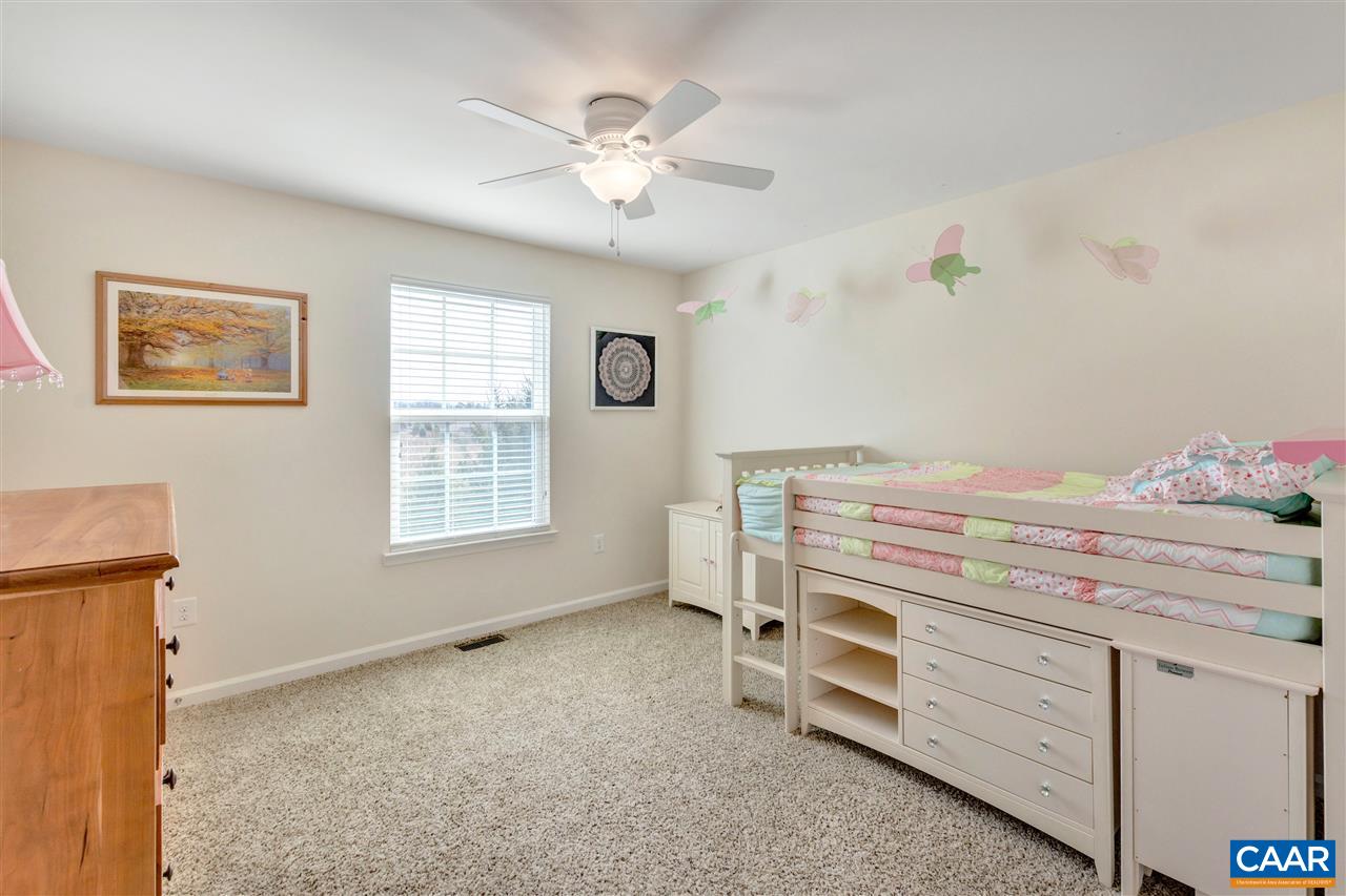 365 Ridgemont Road Ruckersville, VA 22968 - Photo 34 of 50 a bedroom with a bed and a chandelier